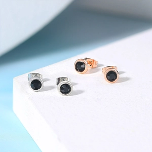 4mm round black zircon stud earrings in silver and rose gold finishes on stone tray