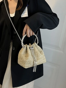 Fashionable straw bucket bag with silver ring handle and tassel drawstring detail