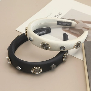 Close-up of handmade velvet headband with grey crystals and white pearls detail