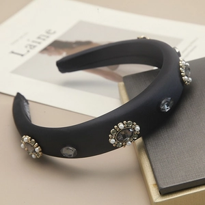 Detail of a velvet headband with hand-set grey stones, pearls and floral crystals