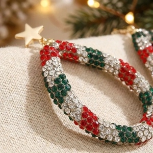 Detailed close-up of Christmas teardrop hoop earrings with red green and white rhinestones