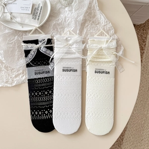 Three pairs of lace mesh mid-calf socks with ribbons in black, white, and cream white