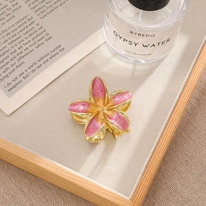 Elegant gold-tone bohemian flower hair claw clip with pink and yellow enamel petals