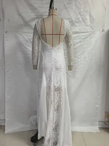 Detail of white lace wedding dress featuring elegant open back and floral embroidery