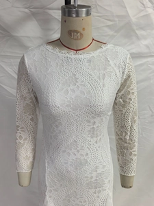 Detailed view of the geometric hollow lace pattern on this elegant white evening dress