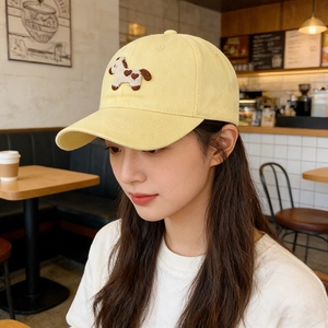 Close-up of beige cotton baseball cap featuring detailed pony embroidery and stitching