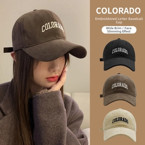 Detail of white COLORADO embroidery on soft textured corduroy baseball cap with wide brim