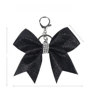 Glitter bow keychain with rhinestone details showing dimensions 12cm by 10cm