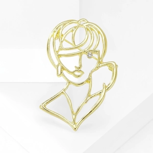 Detail of artistic hollow gold-plated portrait brooch with small crystal eye accent