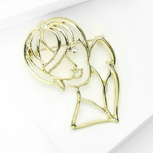 Detailed macro view of a minimalist hollow gold-plated silhouette brooch with a small diamond