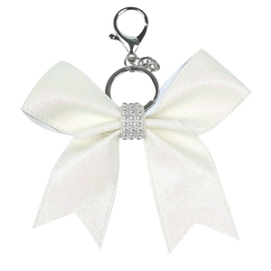 Detail of white bow keychain with glitter finish and rhinestone center on silver ring