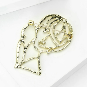 Minimalist gold alloy brooch featuring a hollowed-out female silhouette with hammered texture