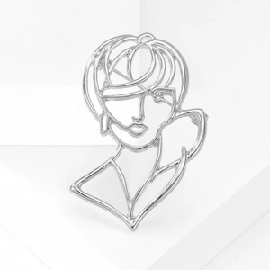 Close-up of a silver hollow portrait brooch with a sparkling rhinestone eye detail