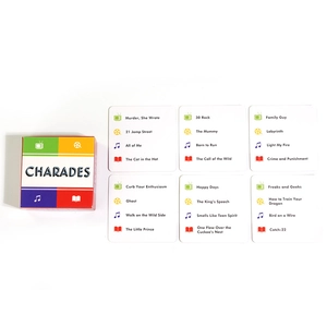Detailed view of Charades board game cards featuring movie and music category prompts