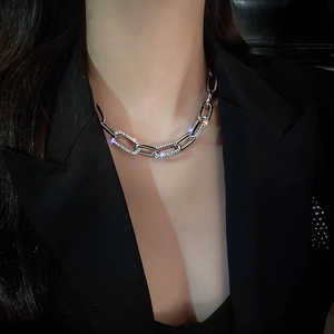 Chunky silver chain necklace with rhinestone pave links worn on a black blazer