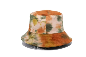 Detailed view of colorful tie-dye bucket hat featuring orange and olive green patterns