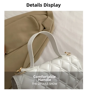 Detail of white quilted handbag featuring gold metal rings and comfortable handle