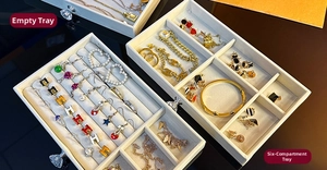 Close-up of three-tier beige velvet jewelry trays with ring slots and divider compartments
