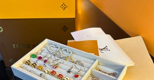 Detailed macro view of high-end assorted jewelry in a luxury grey velvet storage tray