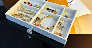Detail view of a 3-tier velvet jewelry organizer tray with diverse compartments and handle