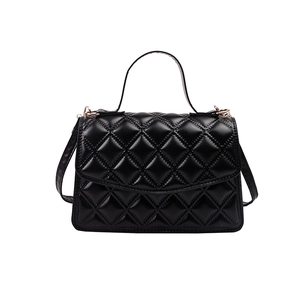 Elegant black quilted leather shoulder bag with chain strap and handle in minimalist style