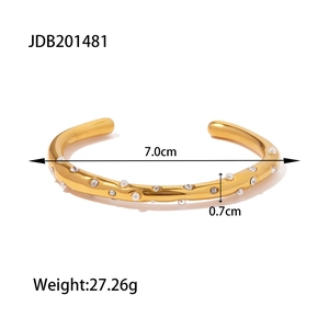 Gold stainless steel open bangle featuring wave design with pearls and round crystals