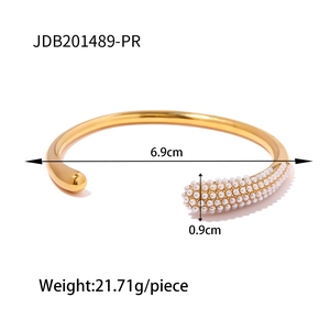 Golden stainless steel open bangle featuring a solid ball and pearl inlay design