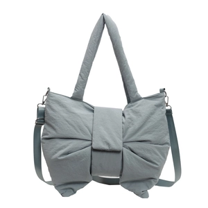 Puffy bow-shaped tote bag in foggy blue nylon with a matching detachable shoulder strap