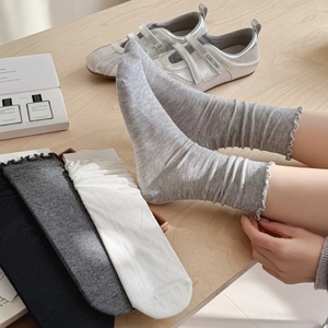 Four-pack of ballet style ruffle trim crew socks in white, black, and grey shades
