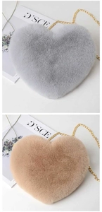 Detailed close-up of heart-shaped faux fur crossbody bag with elegant gold chain strap