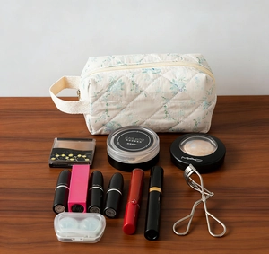 Detail of floral quilted cosmetic bag with makeup products showcasing storage capacity