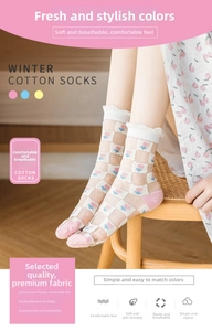 Detail of pink and white checkered cotton socks with red flower patterns and soft texture