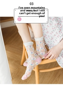 Detail of sheer mesh socks with pink checkerboard pattern and floral embroidery