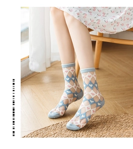 Close-up of mesh socks featuring pink heart patterns and breathable diamond knit fabric