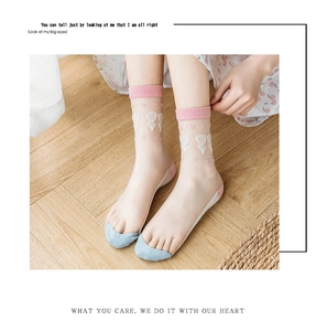 Close-up of sheer glass silk socks featuring white tulip patterns and pink-blue color blocking
