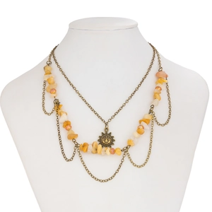 Detail view of retro three-layer necklace with sun pendant and yellow citrine stones
