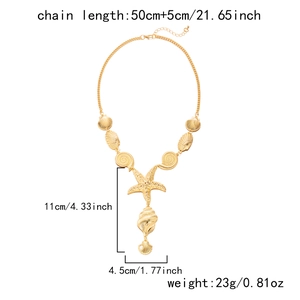 Gold ocean themed necklace with starfish and seashell charms on a white background
