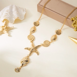 Detailed view of golden starfish and seashell charms on an ocean theme necklace