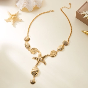 Detailed macro view of golden starfish and seashell pendants on a summer beach necklace