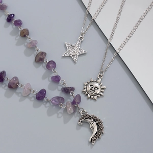 Close-up of celestial moon, sun, and star pendants with purple amethyst stone beads