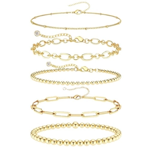 Five-piece gold layered bracelet set featuring paperclip chains and small beads