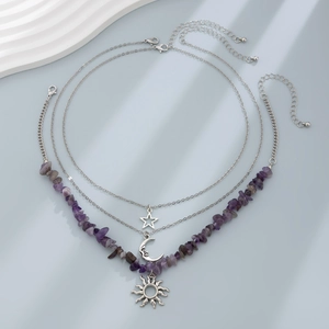 Detailed view of layered silver necklace featuring star, moon, sun pendants and purple stones