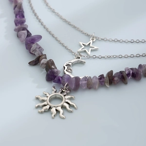 Detailed close-up of triple-layered necklace with purple stone beads and silver moon charms