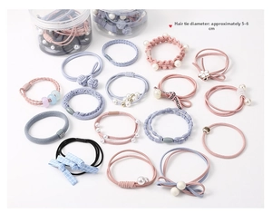 Detail view of assorted elastic hair ties with pearls and bows in pastel colors
