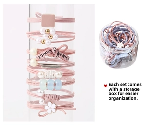 Pink elastic hair ties set with pearls and ribbons including a clear storage box