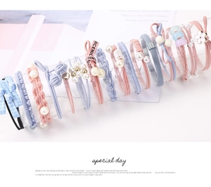 Detail of high-elastic hair ties with pearls, bows, and various macaron colored patterns
