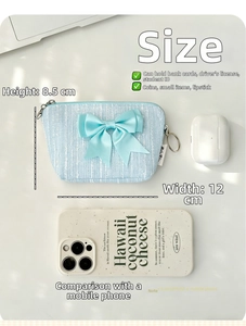 Mini light blue tweed coin purse with bow detail showing size scale with everyday items
