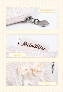 Detail of tweed coin purse with heart zipper pull, brand tag, and satin bow decoration