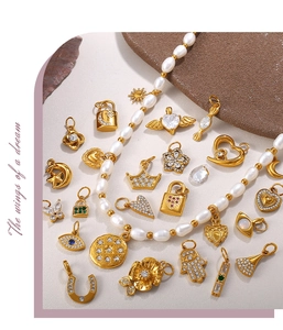 Flat lay of vintage gold-plated pendants and pearl necklace with sparkling zircon accents