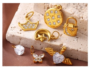 Detailed view of gold plated DIY jewelry pendants with hearts, stars and rhinestones